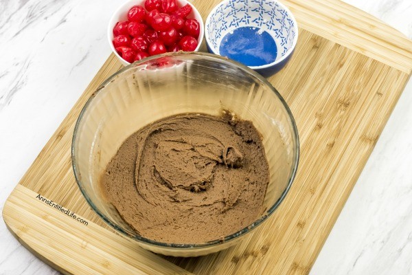 Cherry Cordial Cookies Recipe. A sinfully decadent chocolate cookie surrounds a cherry surprise in the middle! These easy to make cookies are fun and delicious. Your friends and family will love these tasty cookie treats!