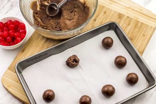 Cherry Cordial Cookies Recipe. A sinfully decadent chocolate cookie surrounds a cherry surprise in the middle! These easy to make cookies are fun and delicious. Your friends and family will love these tasty cookie treats!