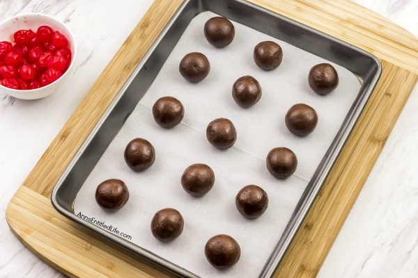 Cherry Cordial Cookies Recipe. A sinfully decadent chocolate cookie surrounds a cherry surprise in the middle! These easy to make cookies are fun and delicious. Your friends and family will love these tasty cookie treats!