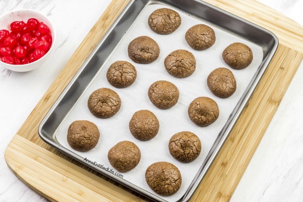 Cherry Cordial Cookies Recipe. A sinfully decadent chocolate cookie surrounds a cherry surprise in the middle! These easy to make cookies are fun and delicious. Your friends and family will love these tasty cookie treats!