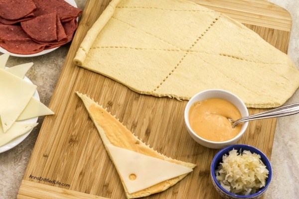 Reuben Crescent Rolls Recipe. These delightful little rolls are a fantastic combination of corned beef, Swiss cheese, sauerkraut, and Thousand Island dressing for a new version of the old favorite deli sandwich. These Reuben crescent rolls are wonderful for serving as an appetizer, snack, or enjoying two or three for your lunch!