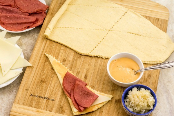 Reuben Crescent Rolls Recipe. These delightful little rolls are a fantastic combination of corned beef, Swiss cheese, sauerkraut, and Thousand Island dressing for a new version of the old favorite deli sandwich. These Reuben crescent rolls are wonderful for serving as an appetizer, snack, or enjoying two or three for your lunch!