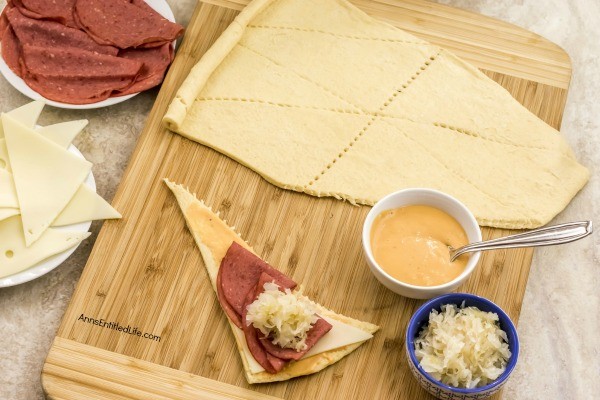 Reuben Crescent Rolls Recipe. These delightful little rolls are a fantastic combination of corned beef, Swiss cheese, sauerkraut, and Thousand Island dressing for a new version of the old favorite deli sandwich. These Reuben crescent rolls are wonderful for serving as an appetizer, snack, or enjoying two or three for your lunch!