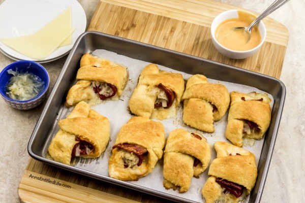 Reuben Crescent Rolls Recipe. These delightful little rolls are a fantastic combination of corned beef, Swiss cheese, sauerkraut, and Thousand Island dressing for a new version of the old favorite deli sandwich. These Reuben crescent rolls are wonderful for serving as an appetizer, snack, or enjoying two or three for your lunch!