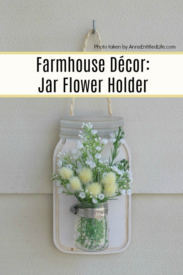 Farmhouse Décor: Jar Flower Holder. This adorable little jar flower holder is easy to make, rustic decor. Great for indoor or outdoor decorating, this sweet little bud vase fills in that small section of open wall space perfectly. This step-by-step tutorial will show you exactly how to make this simple DIY farmhouse décor jar flower holder inexpensively.