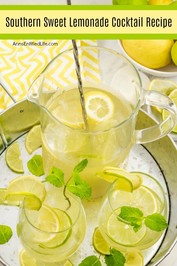 An overhead view of a pitcher of southern lemonade and two filled glasses on a galvanized tray. There is a bowl of lemons in the upper left, a small bowl of cut limes below that.