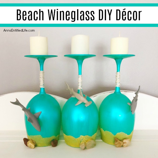 Beach Wineglass DIY Décor. Make your own beach themed wineglasses with these easy step-by-step tutorial instructions. This is a great summertime craft, makes a fabulous shark week decoration, or if you have beach themed décor in your home or on your lanai, patio or in your three-season room, this is a fun and funky craft project to add to it. These highly customizable beach wineglasses are simple to make and will look great on your mantel, side table or as part of a larger décor theme.