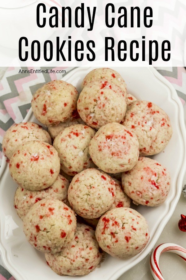 a white plate of round candy cane cookies on a pink and grey chevron background