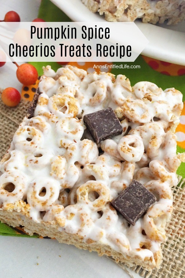 one square pumpkin spice Cheerios on top of a piece of burlap, with a second piece on a white dish