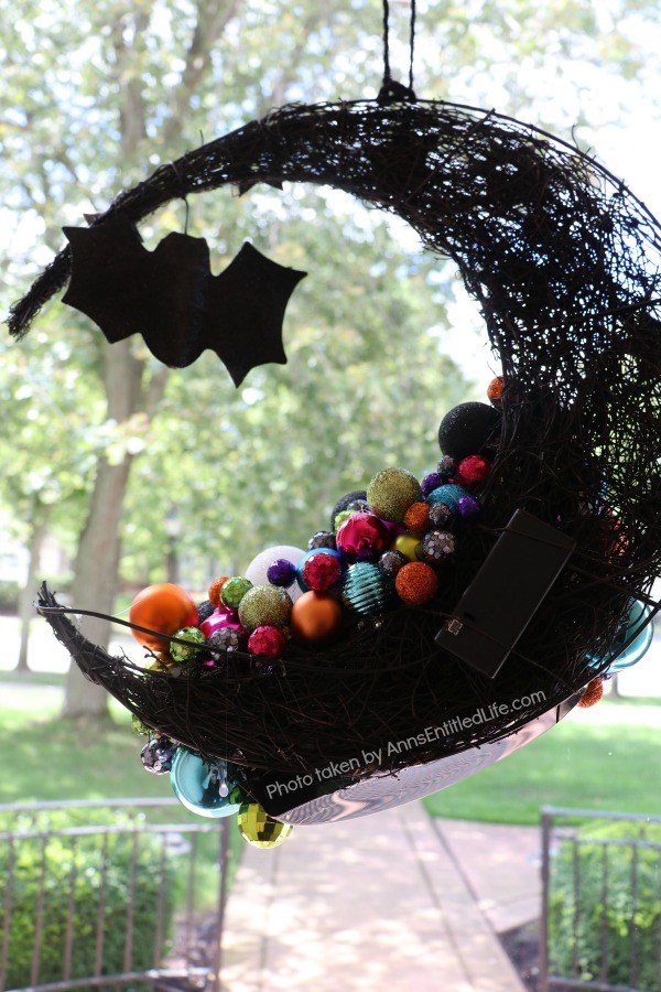 Homemade Halloween Witch's Cauldron Wreath. A step by step guide on making a halloween wreath inspired by a witch's cauldron! This easy to follow tutorial teaches you how to make a halloween witch's cauldron wreath. This wreath is perfect Halloween door decor your trick or treaters will love!