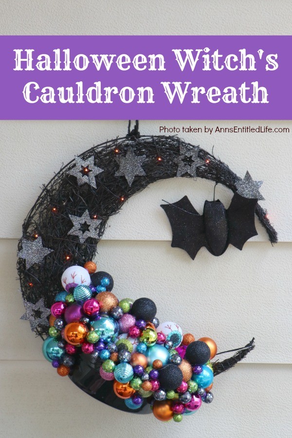 multicolored bulbs formed to imitate bubbles flowing from the cauldron attached to a half-moon black prelit wreath, hanging on a yellow