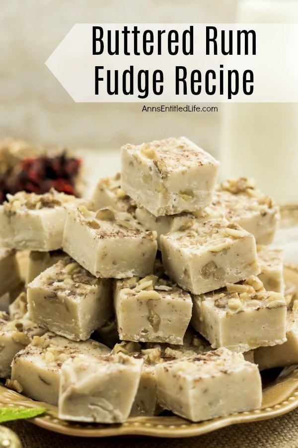 A straight on view of square cut pieces of butter rum fudge on a gold plate. The plate is set upon burlap.