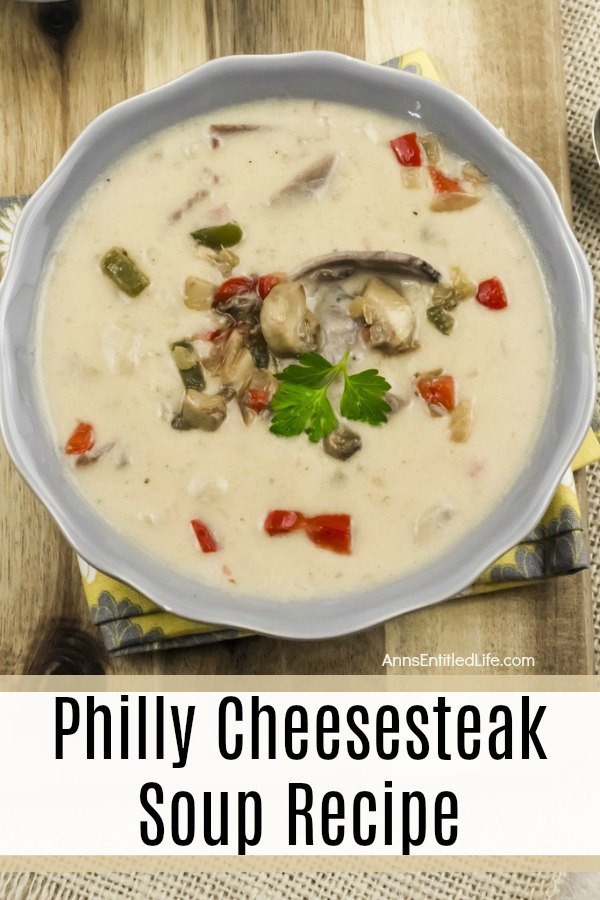 Overhead view of a blue bowl filled with Philly cheesesteak soup garnished with mushrooms and peppers