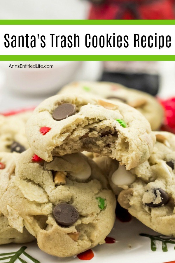 A close-up of a bitten Santa Trash cookie balanced on top of several whole Santa trash cookies.