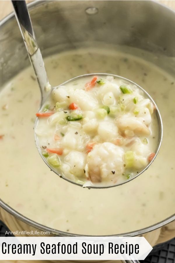 a ladle full of creamy seafood soup being lifted from the pot