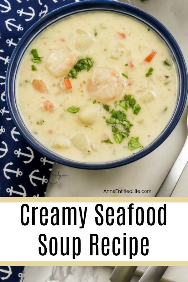 creamy seafood soup in a blue bowl on top of a blue anchor patterned napkin