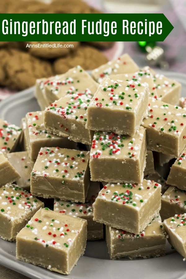 A grey serving platter filled with cut pieces of gingerbread fudge. There is a plate of gingersnap cookies in the upper left.