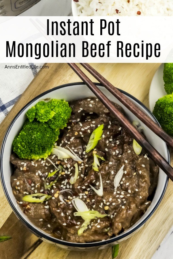 Overhead shot of Mongolian beef in a white, blue-rimmed bowl. The beef is sprinkled with sesame seeds. There are chopsticks resting across the bowl. There is a small bowl of rice in the upper right.