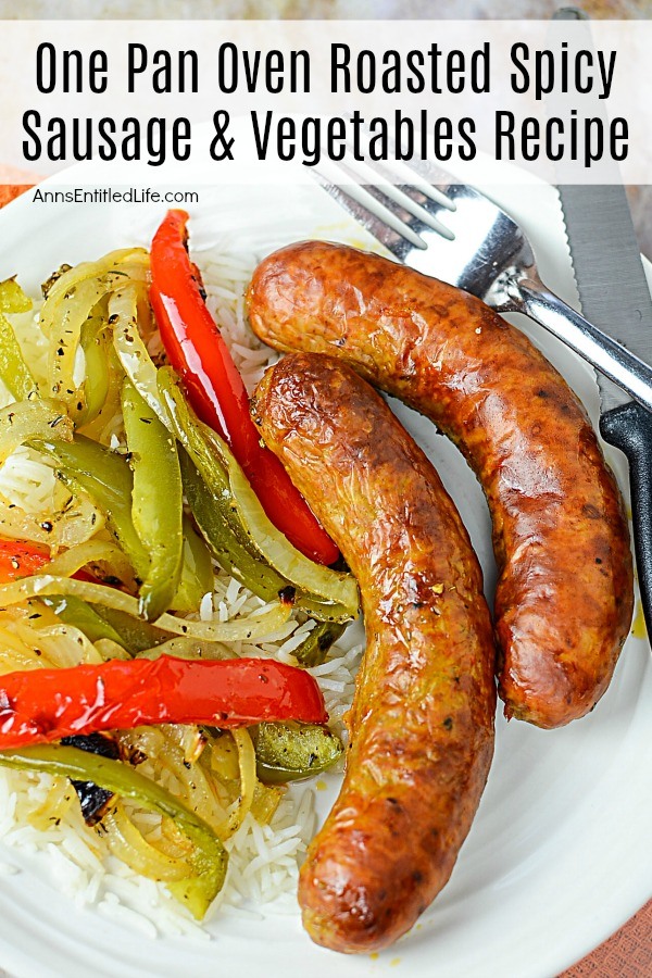 Two cooked sausages next to cooked peppers and onions on a bed of rice atop a white plate, serving utensils to the right