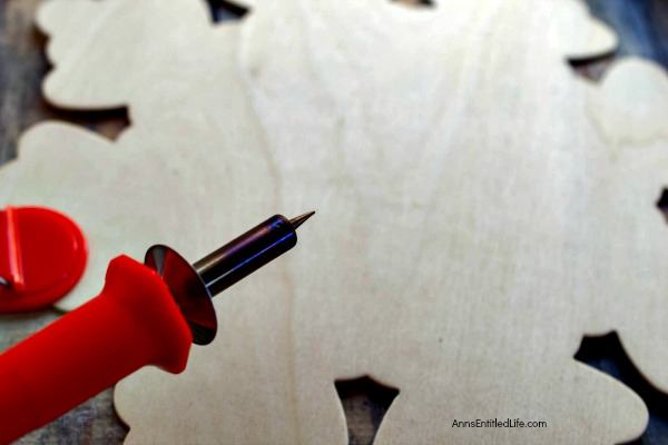 Wood Burned Snowflake Craft. Looking for some great winter decor? These easy to make wood burned snowflakes will look great hanging in your window, from a lamp or chandelier, or decorating your cupboards.