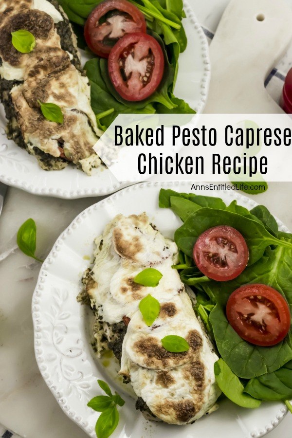 Overhead shot of a serving of chicken with mozzarella on top of it, tomato and lettuce side dish on a white plate. There is a second, identical plated chicken in the upper left.