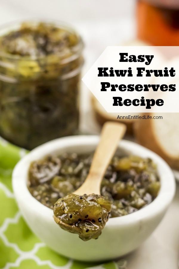 A close-up  view of kiwi fruit preserves on a wooden spoon atop a white bowl also filled with kiwi fruit preserves, a Mason jar of the same preserves is in the background, all on a green checked napkin. There is a side of bread to the right.