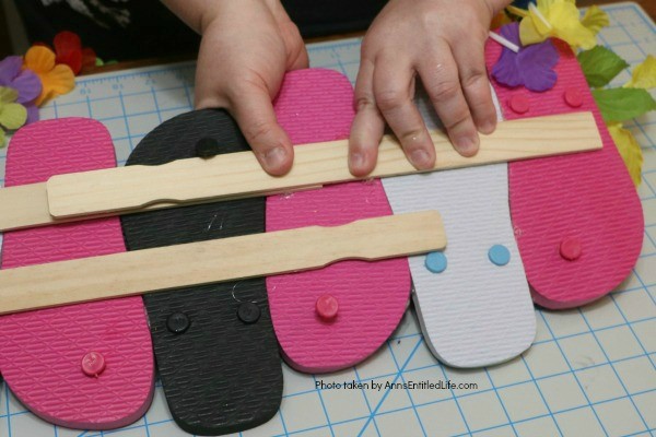 Flip Flops Door Hanger: Dollar Store Craft. Make this cute flip flop door hanger in no time flat with materials found at your local dollar store! This quick and easy project is inexpensive and great for summertime, tropical parties, or classroom decorations.