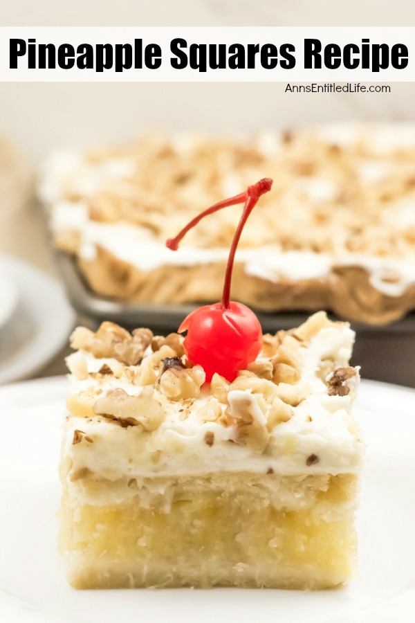 A piece of pineapple square on a white plate, a pan of frosted pineapple squares topped with crushed walnuts in the background