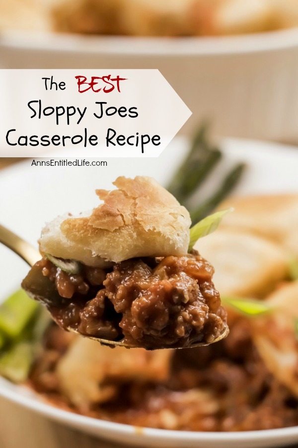 A forkful of sloppy joes casserole lifted from a white plate of sloppy joes casserole, the casseole dish is in the back right.