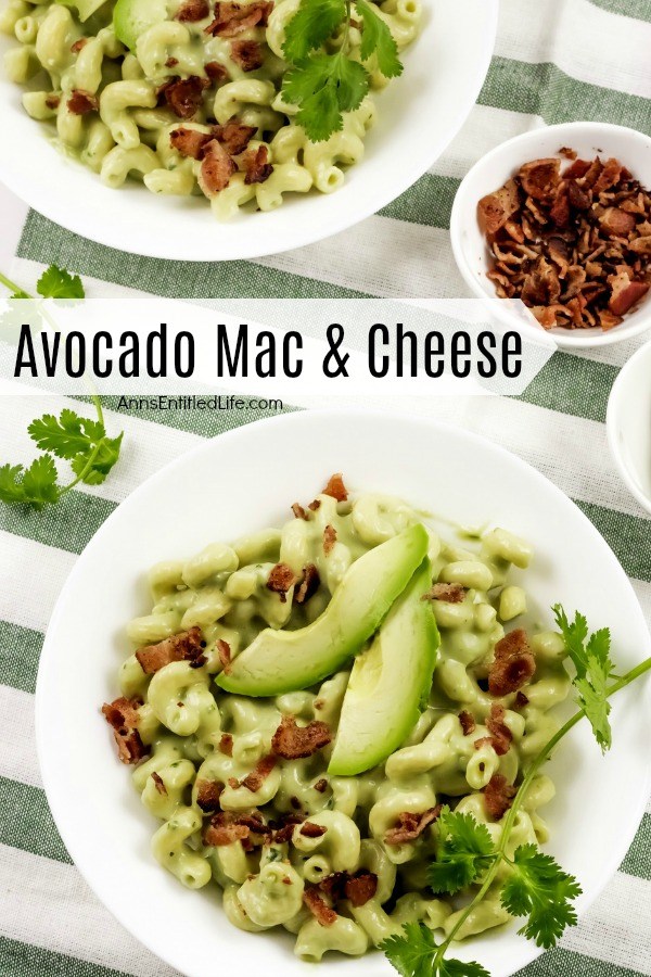 Two white plates filled with avocado mac and cheese on a green and white napkin, a small bowl of bacon to the right