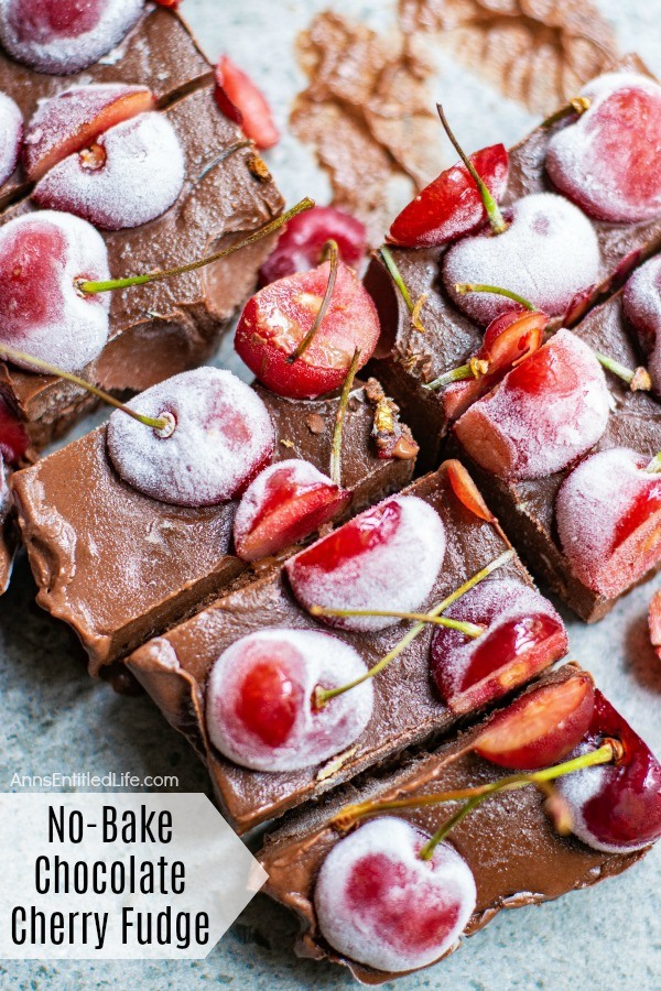 A close-up of an overhead shot cut fresh cherry chocolate fudge cut into multiple pieces and a blue board.