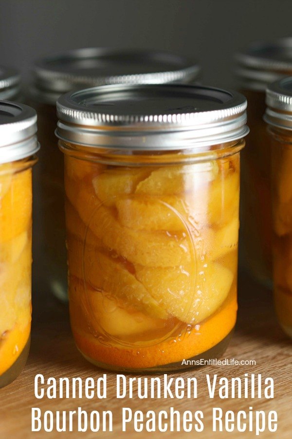 Close-up photo of a pint of home-canned vanilla bourbon peaches, there are five other pint-size cans surrounding it one on each side that are partially shown, the back row only lids are visible