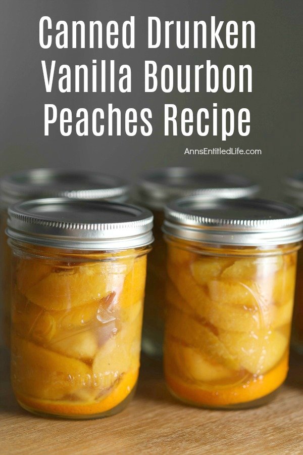 Two pints of home-canned vanilla bourbon peaches are front and center on a brown mat, the back row only lids are visible, against a grey background