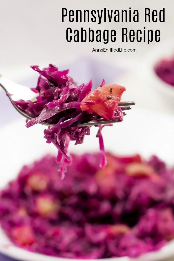 A close-up of a forkful of Pennsylvania red cabbage with a bowl filled with the cooked cabbage in the background.