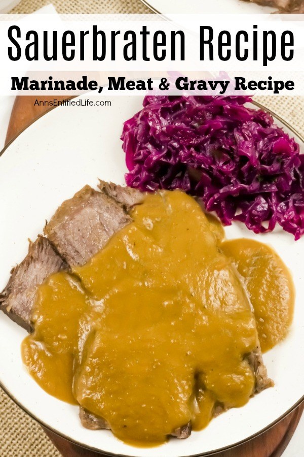 A white plate filled with a serving of sauerbraten, gravy, and Pennsylvania red cabbage on a brown placemat