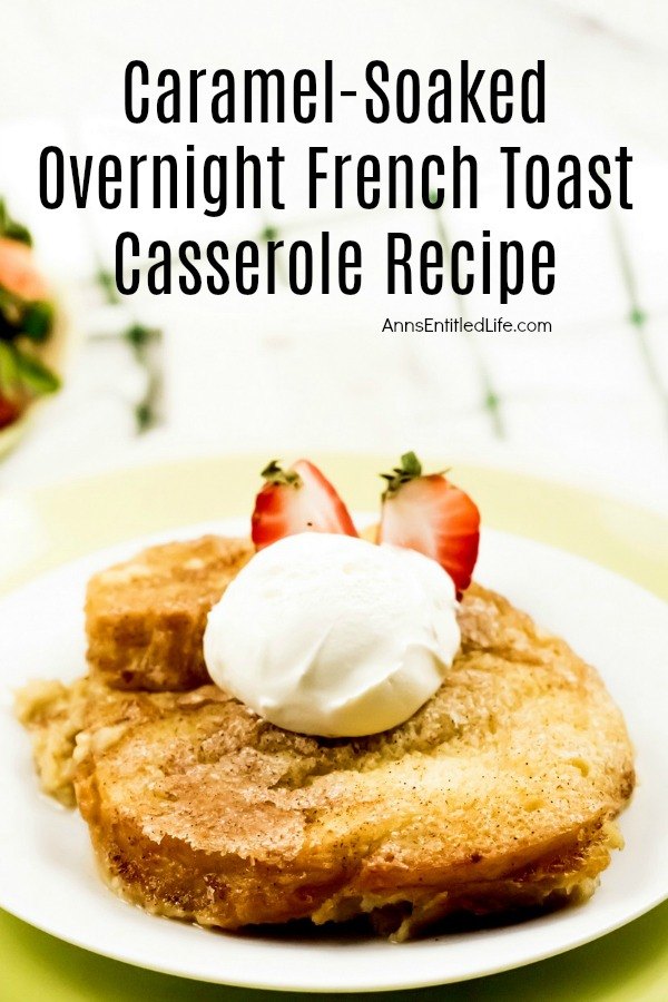 a serving of caramel-soaked French toast casserole on a white plate. There is a dollop of whipped cream on top, as well as a fresh strawberry. 