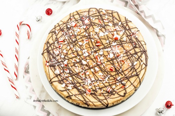 Candy Cane Cheesecake Recipe. Make a classic flavor of the holidays even better by preparing and serving this Candy Cane Cheesecake recipe for your friends and family! It has a cool, minty taste paired with a creamy cheesecake base. Topped off with chocolate drizzle and pieces of candy cane, this candy cane cheesecake has a picture perfect presentation.