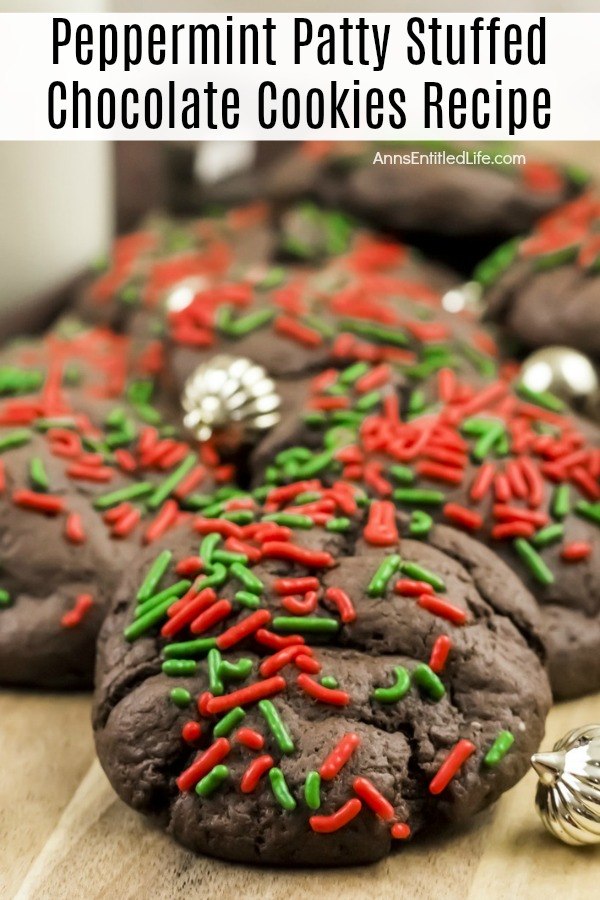 An up-close look at a cutting board filled with peppermint patty chocolate cookies. There are small gold ornaments decorating the pile.