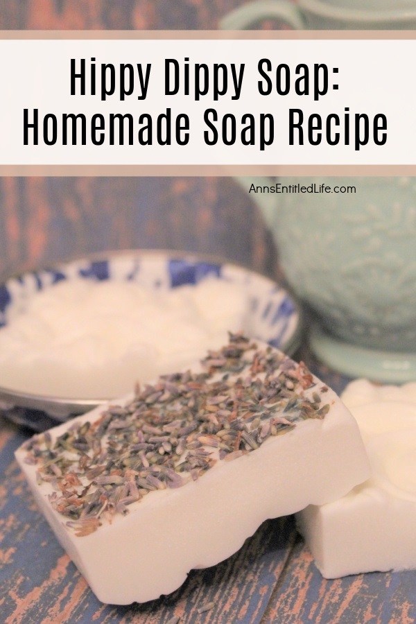 two homemade soaps on a wooden board, there is a blue plate in the left background, a green pitcher in the right background