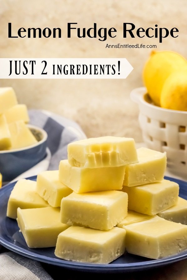 A side view of a blue plate filled with cut square of lemon fudge, the top piece has a bite removed. There is a basket of fresh lemons to the right, more fudge in a blue bowl to the left.