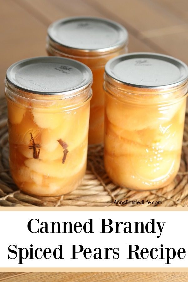 Three jars of canned brandy spiced pears sitting on a rattan placemat