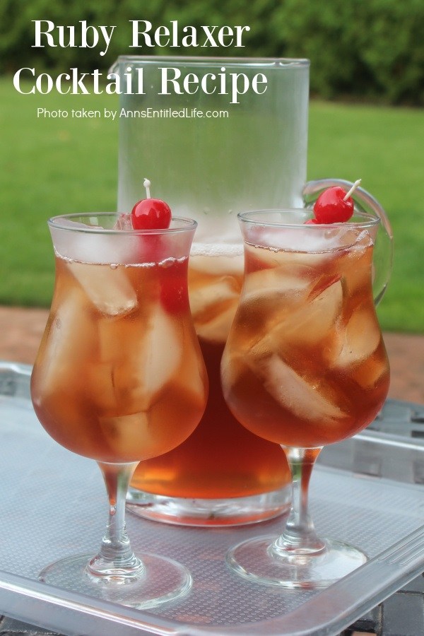 Two glasses and a pitcher of ruby relaxer cocktail set on a plastic tray in a backyard