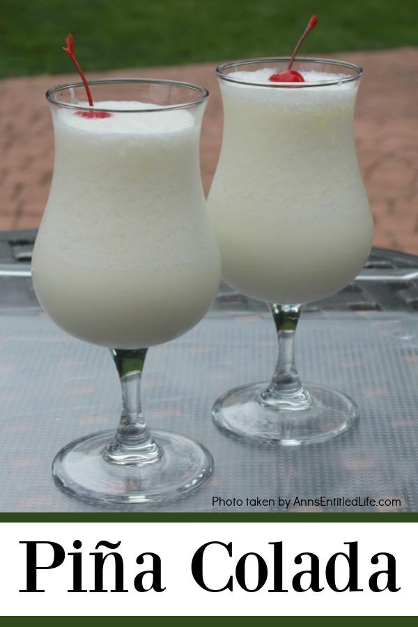 two pina colada cocktails side by side on a clear tray set atop an outdoor table in a backyard