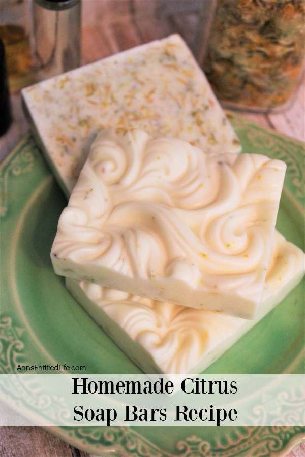 3 bars of citrus soap on a green plate, two showing the patterned top, one showing the back