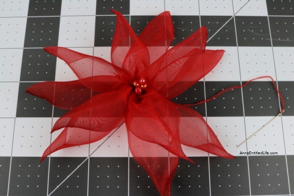 How to Make Poinsettia Ribbon Flowers. Follow these step-by-step instructions on how to make these easy poinsettia ribbon flowers with clips that you can display around your home or office. This is an easy craft once you get the hang of it. This fun craft will give you new accents for holiday decorations this Christmas season.