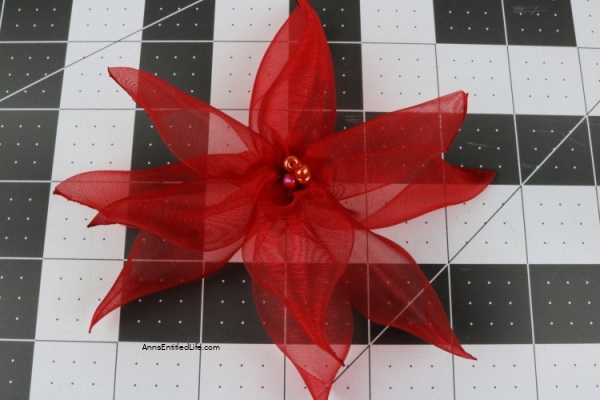 How to Make Poinsettia Ribbon Flowers. Follow these step-by-step instructions on how to make these easy poinsettia ribbon flowers with clips that you can display around your home or office. This is an easy craft once you get the hang of it. This fun craft will give you new accents for holiday decorations this Christmas season.