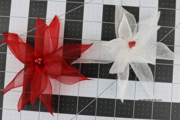 How to Make Poinsettia Ribbon Flowers. Follow these step-by-step instructions on how to make these easy poinsettia ribbon flowers with clips that you can display around your home or office. This is an easy craft once you get the hang of it. This fun craft will give you new accents for holiday decorations this Christmas season.