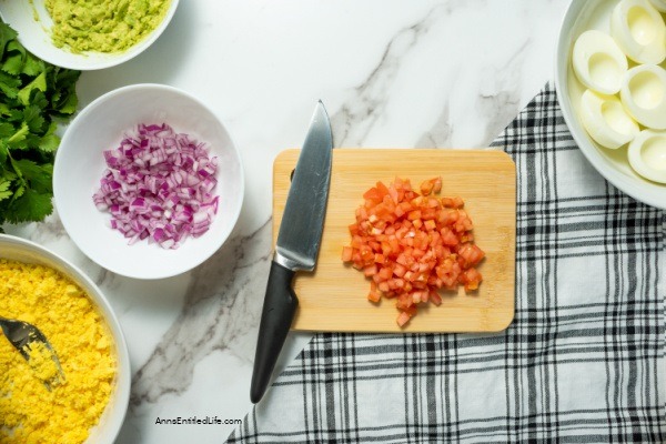 Avocado Deviled Eggs Recipe. These guacamole-inspired deviled eggs that are made with avocado, lime, tomato, and onion are simply delicious! Easy-to-make these avocado deviled eggs are a perfect party appetizer, great for picnics, tailgating, or for a snack for those on low-carb diets.