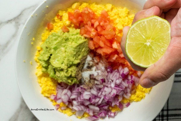 Avocado Deviled Eggs Recipe. These guacamole-inspired deviled eggs that are made with avocado, lime, tomato, and onion are simply delicious! Easy-to-make these avocado deviled eggs are a perfect party appetizer, great for picnics, tailgating, or for a snack for those on low-carb diets.