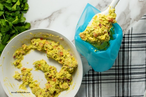 Avocado Deviled Eggs Recipe. These guacamole-inspired deviled eggs that are made with avocado, lime, tomato, and onion are simply delicious! Easy-to-make these avocado deviled eggs are a perfect party appetizer, great for picnics, tailgating, or for a snack for those on low-carb diets.